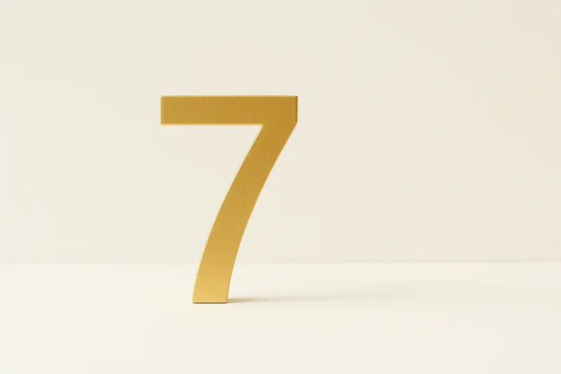 Large golden seven symbol on cream background with soft shadow